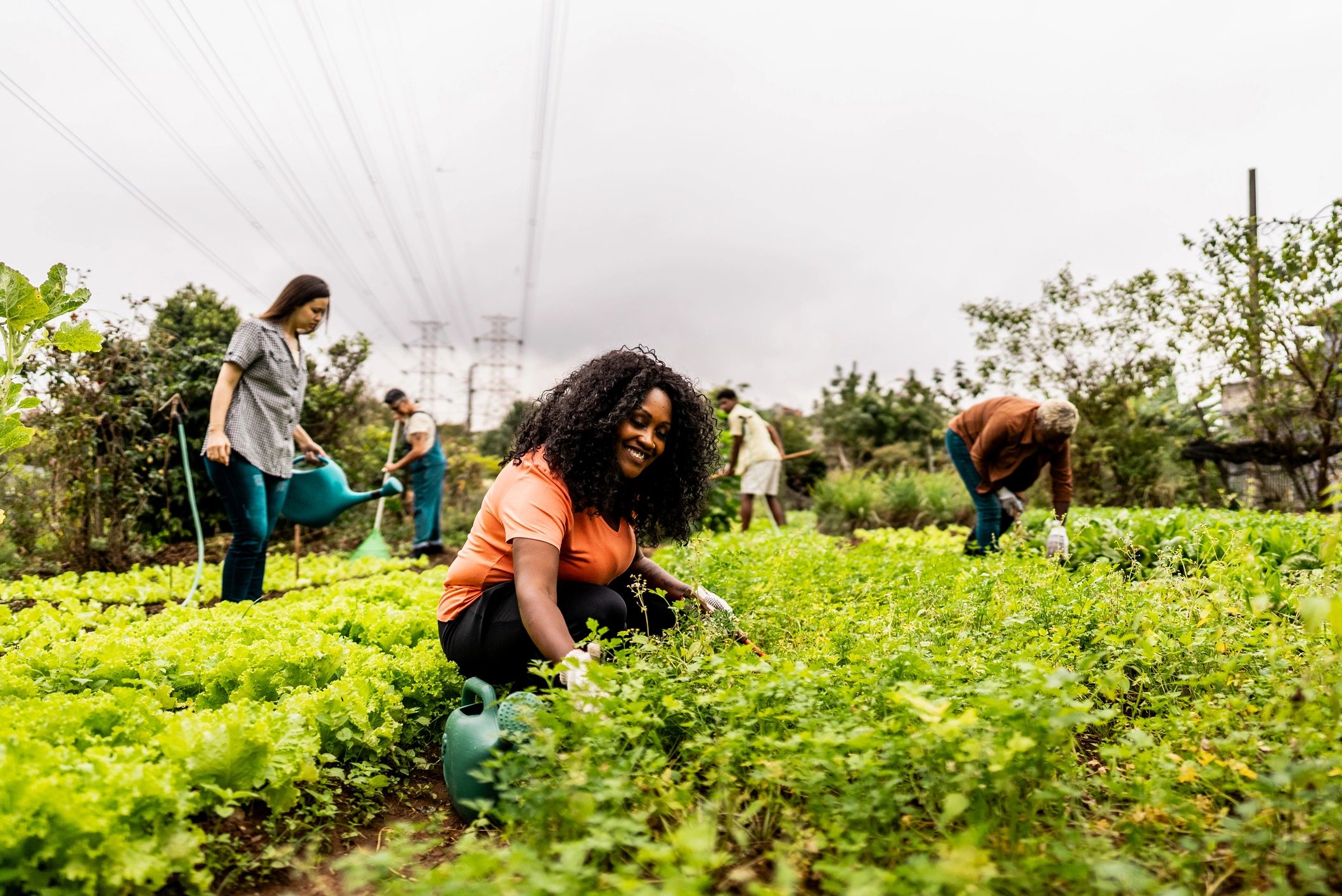 Woman working in a community garden representing agricultural worker resilience