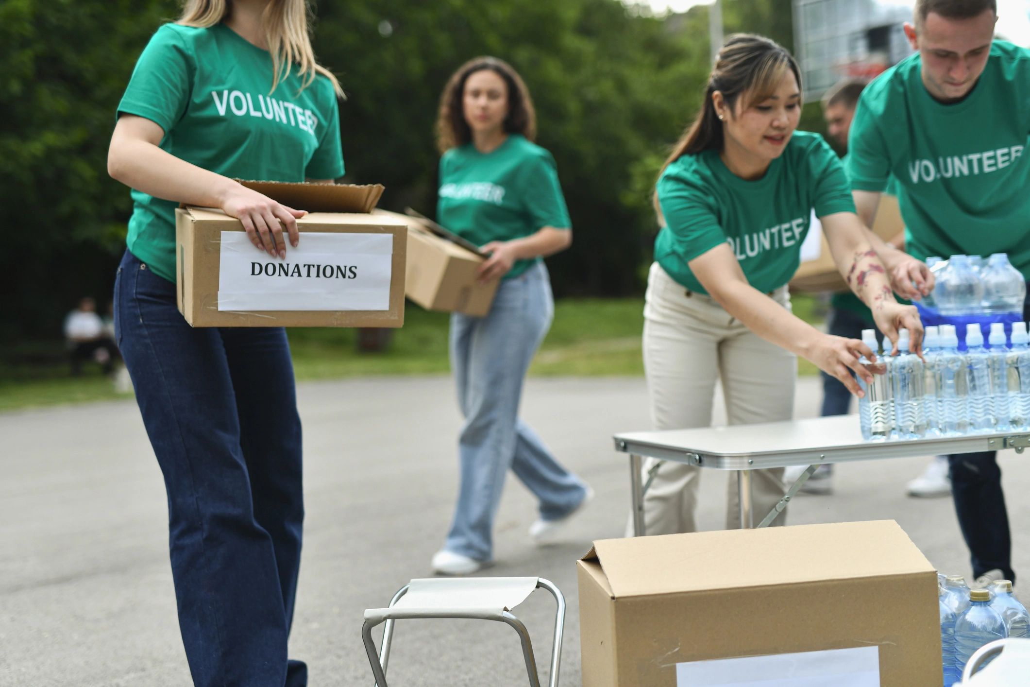 Volunteers organizing materials for an outdoor community support event